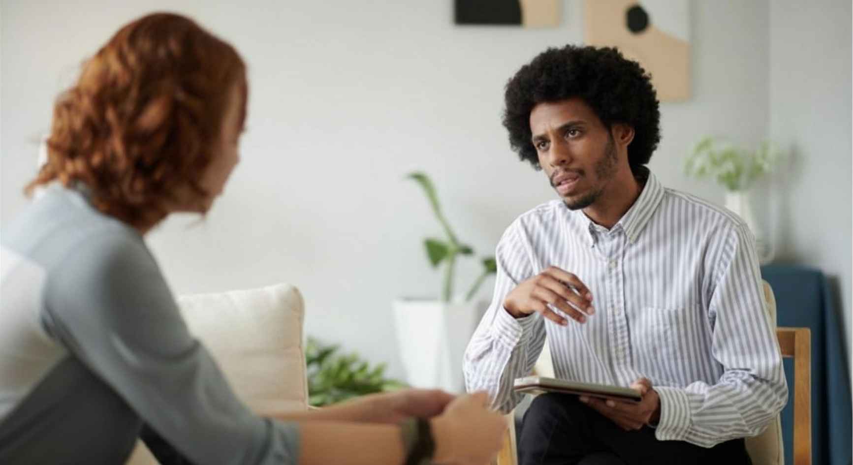 Counselor listening closely to a client during a private session