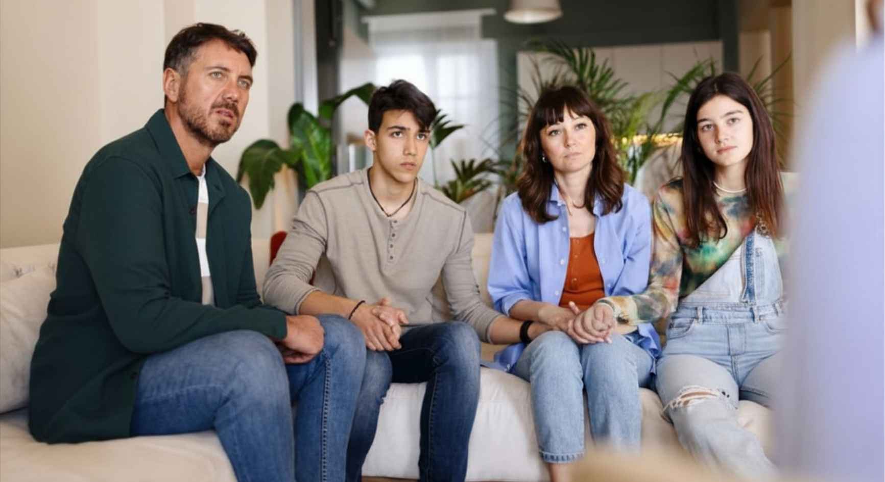 Family of four sitting together on a couch during family therapy for addiction