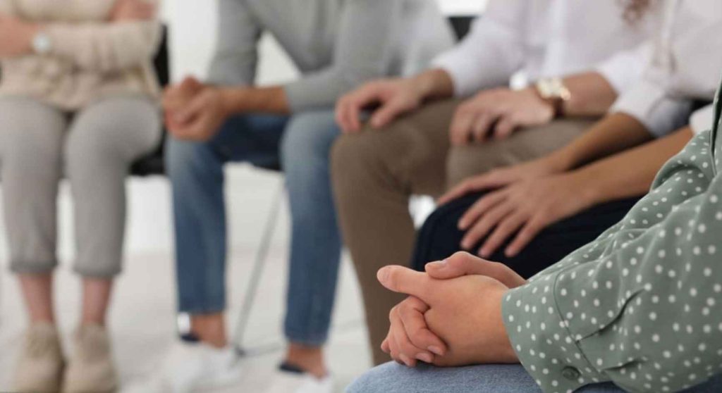 Group of people seated in a circle during a substance abuse counseling session