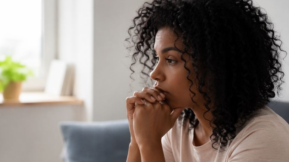 Recovery Coach vs. Sponsor Which Type of Support Is Right for You hero image of woman thinking of the difference.