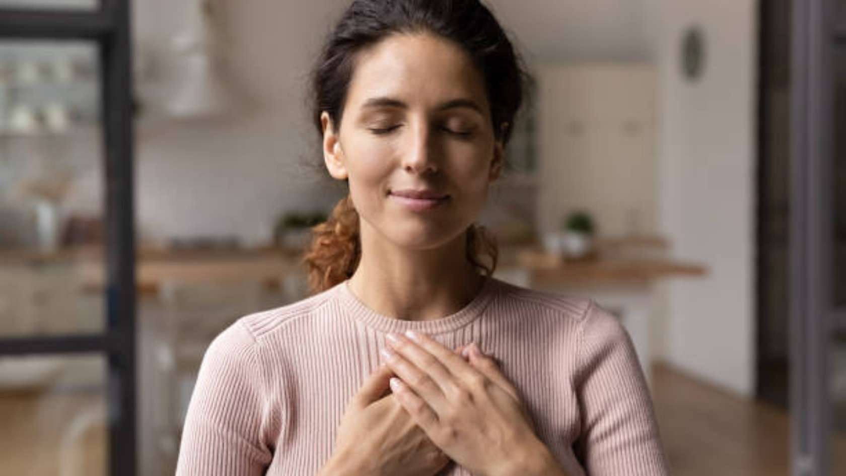 Therapist taking notes while young woman speaks during counseling session