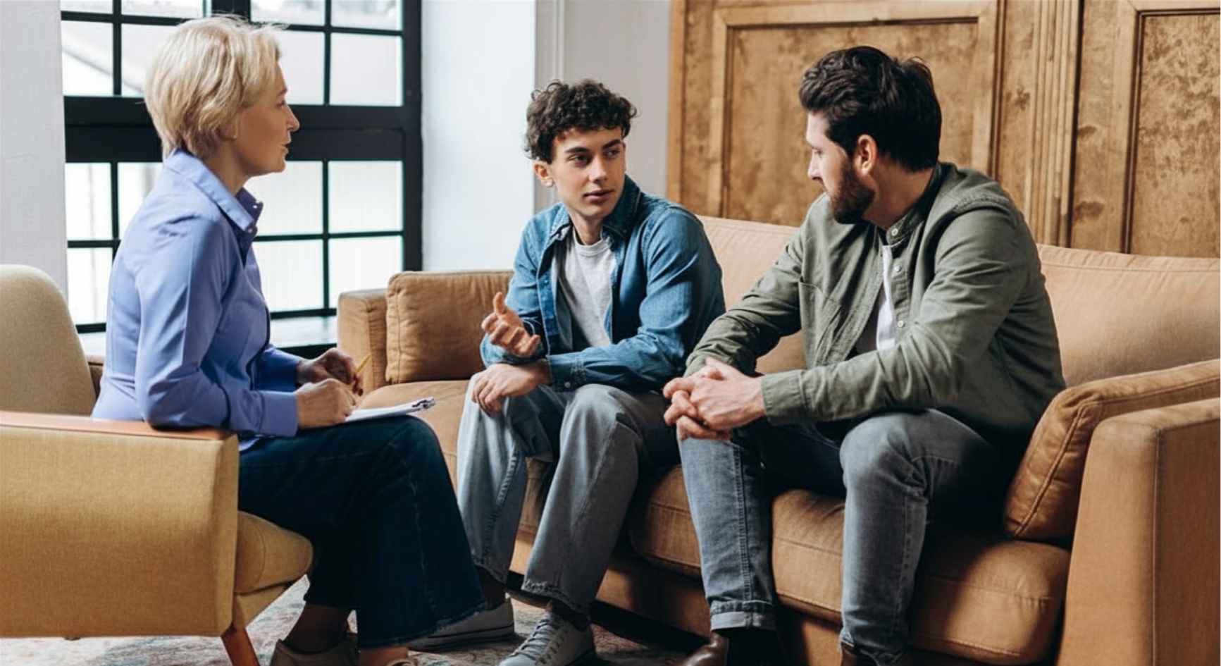 Young couple talking to a female therapist during a counseling session