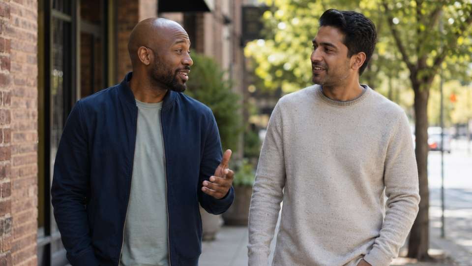 What Does a Recovery Coach Do hero image of a recovery coach walking with a client on the street.